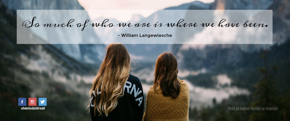 Photograph of two young women looking out at the mountains, with a quote from William Langewiesche: So much of who we are is where we have been.