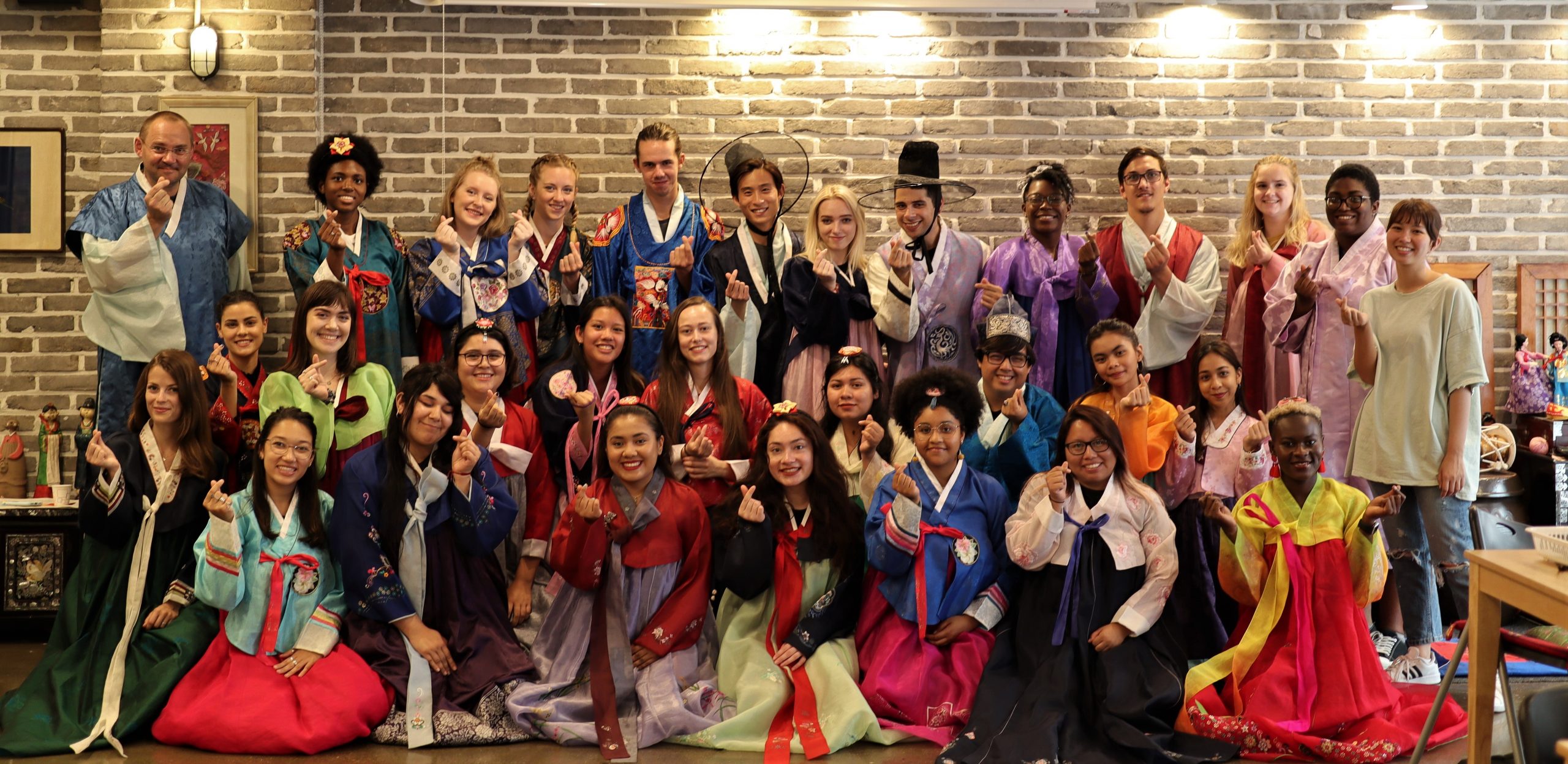 Study Abroad students at Dankook University dressed in hanbok and posing for a group picture.