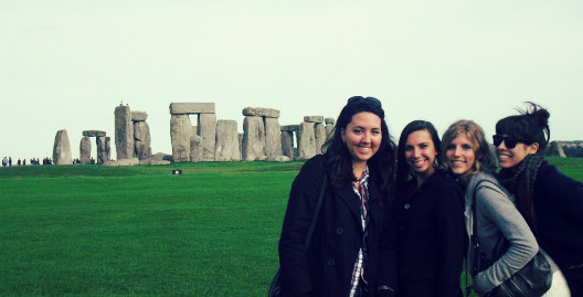 Makana posing with three friends in front of Stone Henge.